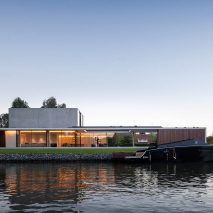Govaert & Vanhoutte Architects creates bachelor pad with underground club on Ghent’s Leie river