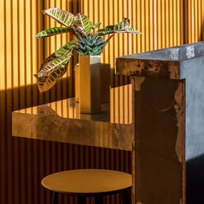 Cement grey meets bright ochre in Grzywinski + Pons’ London restaurant interior