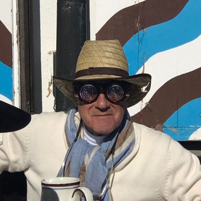 Norman Foster wearing spiral glasses