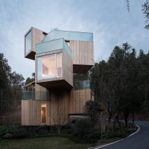 Stacked boxes form Bengo Studio’s towering Tree House hotel in rural China