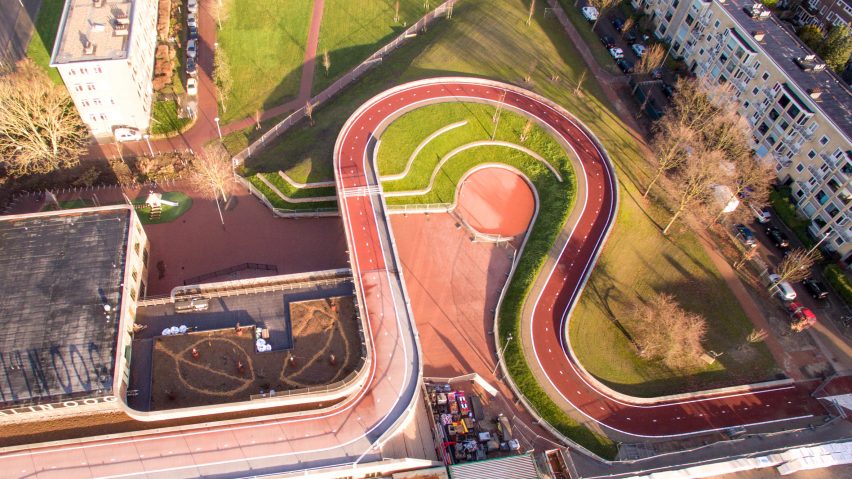 Red cycle path by NEXT and Rudy Uytenhaak snakes over Utrecht school and canal