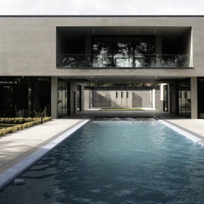 Elevated walkway bridges two parts of Iranian holiday home divided by swimming pool