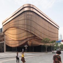Foster and Heatherwick complete Shanghai theatre with curtain-like facade