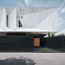 Openbox Architects tops Bangkok house with “monolithic piece of marble sculpture”