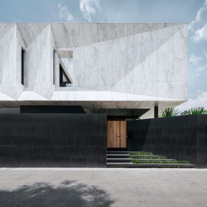 Openbox Architects tops Bangkok house with “monolithic piece of marble sculpture”