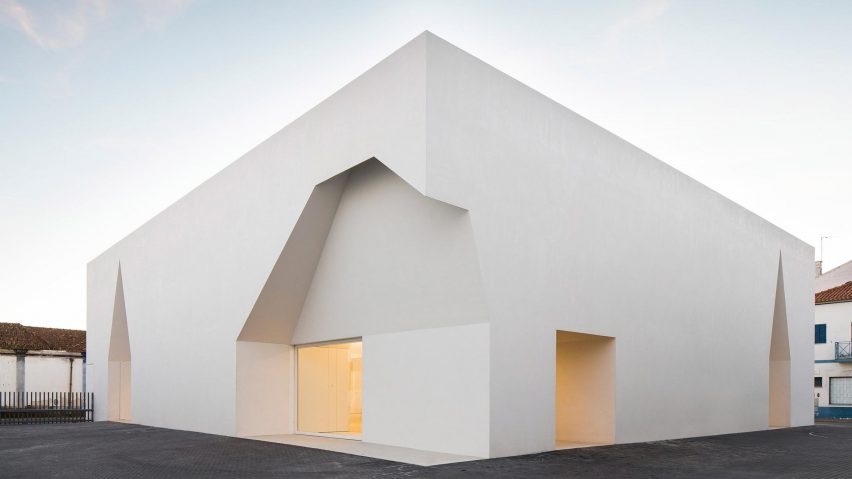 Irregular cutouts mark recessed entrances to Aires Mateus’ community centre in Portugal