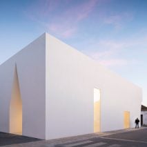 Irregular cutouts mark recessed entrances to Aires Mateus’ community centre in Portugal