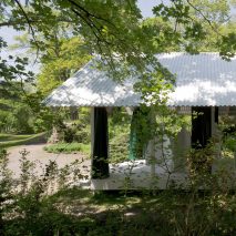 Christ & Gantenbein uses green curtains to merge a pavilion with its parkland setting