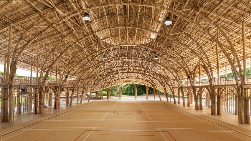 Arched bamboo trusses left exposed in Chiang Mai sports hall to create a “feast to the eye”