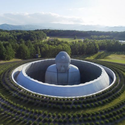 Tadao Ando surrounds huge buddha statue with lavender-covered mound at Sapporo cemetery