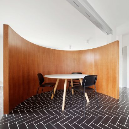 Revamped Barcelona house features herringbone floors and a covert dining area