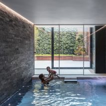 Glass box defines extension with basement pool for Victorian home in south London