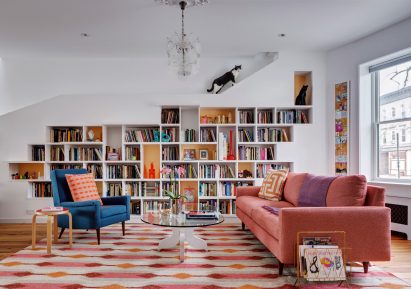 White shelves with a staircase for cats and colourful furniture