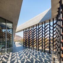 Moveable wooden screens are set into concrete facades of Mokyeonri Wood Culture Museum