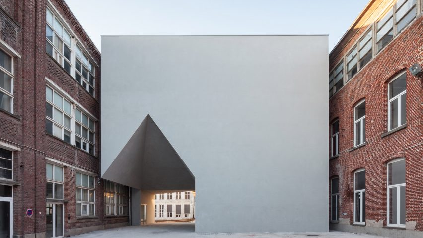 House-shaped opening cuts through Belgian school of architecture by Aires Mateus