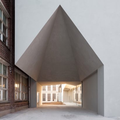 House-shaped opening cuts through Belgian school of architecture by Aires Mateus