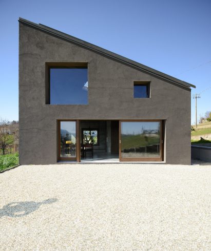 House R by 35a Studio is a concrete holiday home with a twisted roof