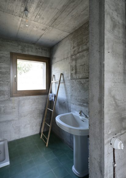 House R by 35a Studio is a concrete holiday home with a twisted roof
