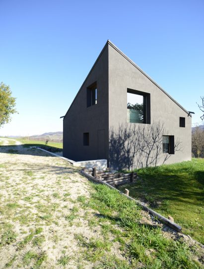 House R by 35a Studio is a concrete holiday home with a twisted roof