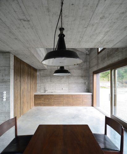 House R by 35a Studio is a concrete holiday home with a twisted roof