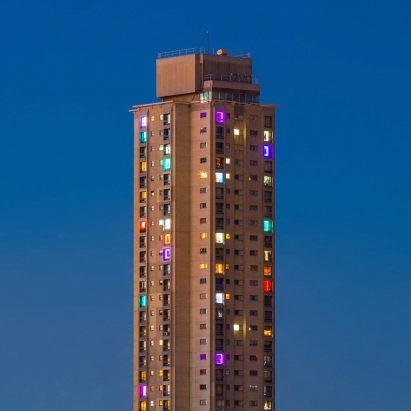Residents of Sydney high-rise estate use lights to protest against gentrification