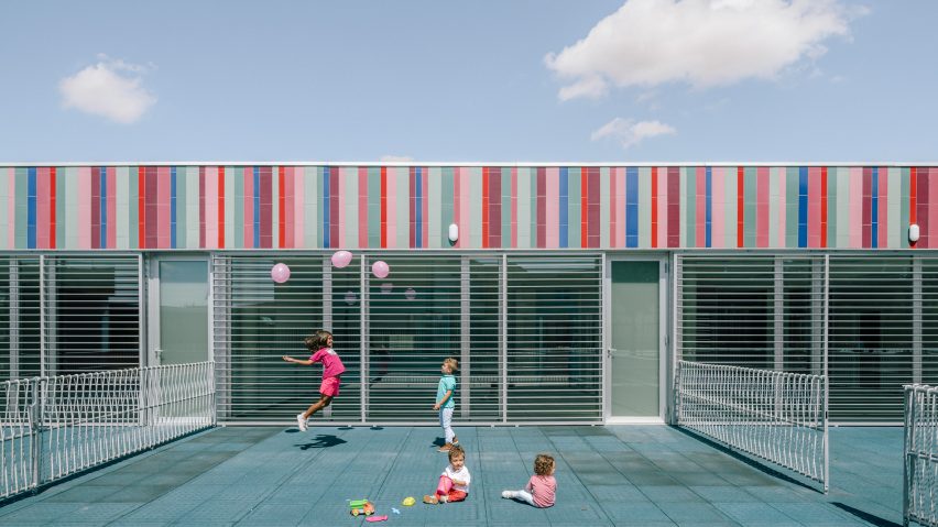 Mirrored panels and stripy tiles cover walls of Spanish school by ABLM Arquitectos