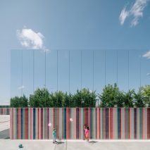 Mirrored panels and stripy tiles cover walls of Spanish school by ABLM Arquitectos