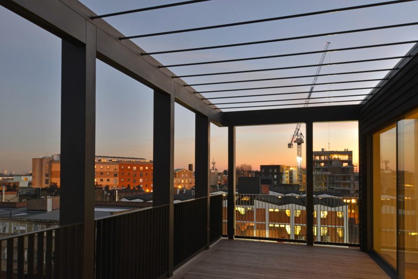 Simon Conder Associates has placed an extension clad in black-stained timber on top of a former warehouse in east London.