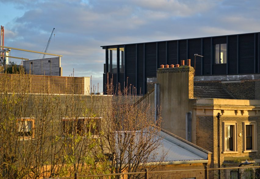 Simon Conder Associates has placed an extension clad in black-stained timber on top of a former warehouse in east London.
