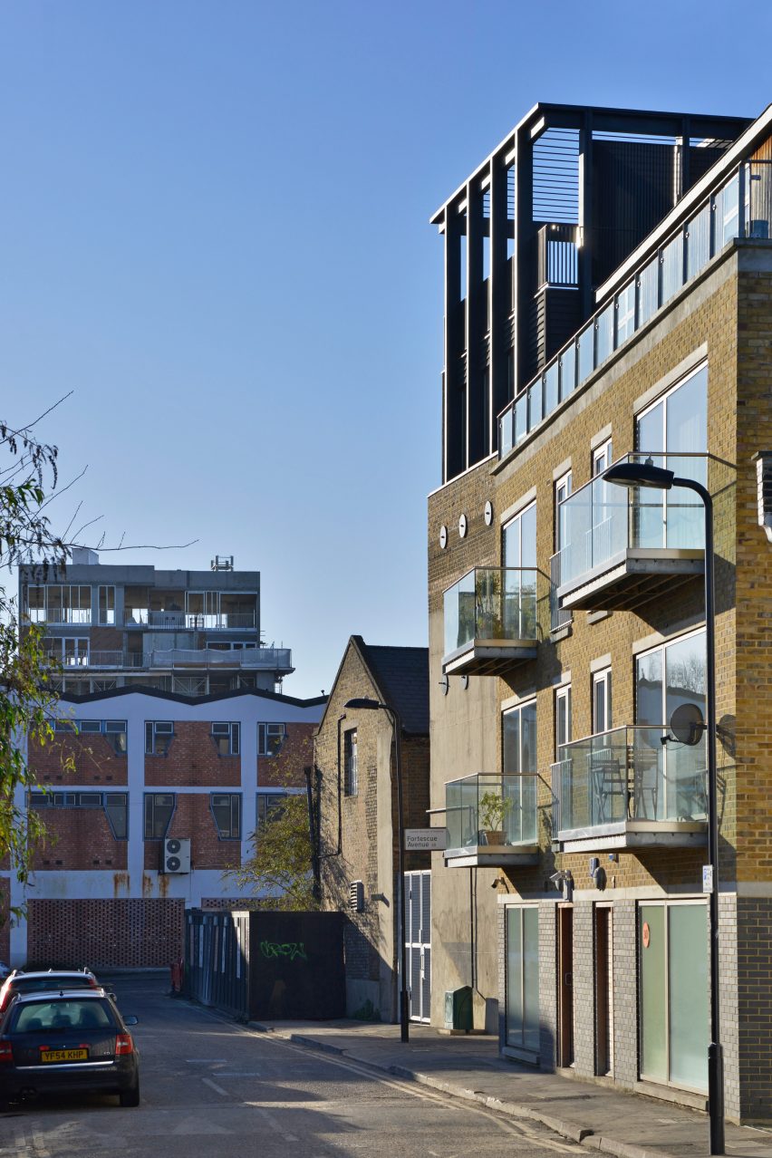 Simon Conder Associates has placed an extension clad in black-stained timber on top of a former warehouse in east London.