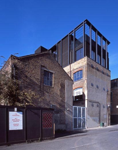 Simon Conder Associates has placed an extension clad in black-stained timber on top of a former warehouse in east London.