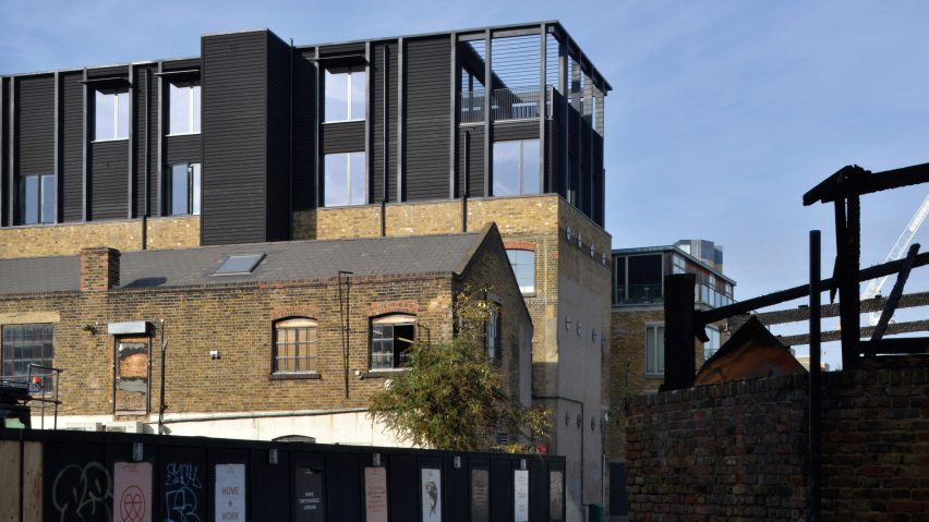 Simon Conder Associates has placed an extension clad in black-stained timber on top of a former warehouse in east London.