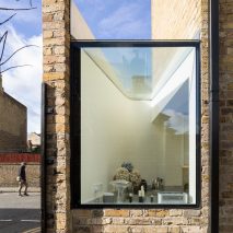 Giant pivoting door connects Columbia Road extension to secluded rear courtyard