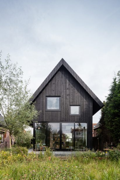 Dutch architect Chris Collaris has completed a house in Amsterdam clad entirely in blackened timber and featuring an asymmetric gabled roof.