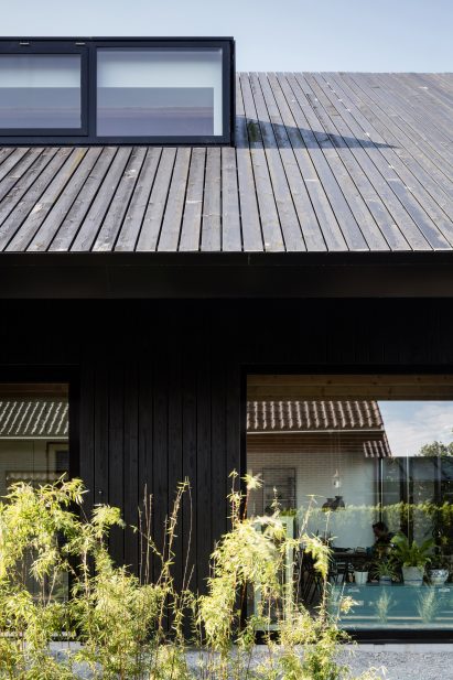 Dutch architect Chris Collaris has completed a house in Amsterdam clad entirely in blackened timber and featuring an asymmetric gabled roof.