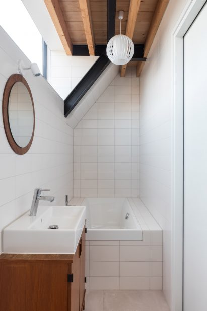 Dutch architect Chris Collaris has completed a house in Amsterdam clad entirely in blackened timber and featuring an asymmetric gabled roof.