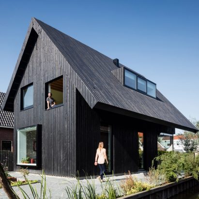 Dutch architect Chris Collaris has completed a house in Amsterdam clad entirely in blackened timber and featuring an asymmetric gabled roof.