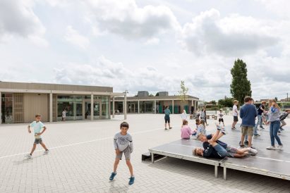 NL Architects completes Belgian school featuring low-lying rooms surrounded by a colonnade