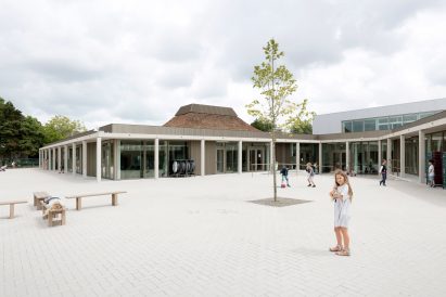 NL Architects completes Belgian school featuring low-lying rooms surrounded by a colonnade