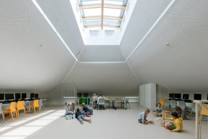 NL Architects completes Belgian school featuring low-lying rooms surrounded by a colonnade