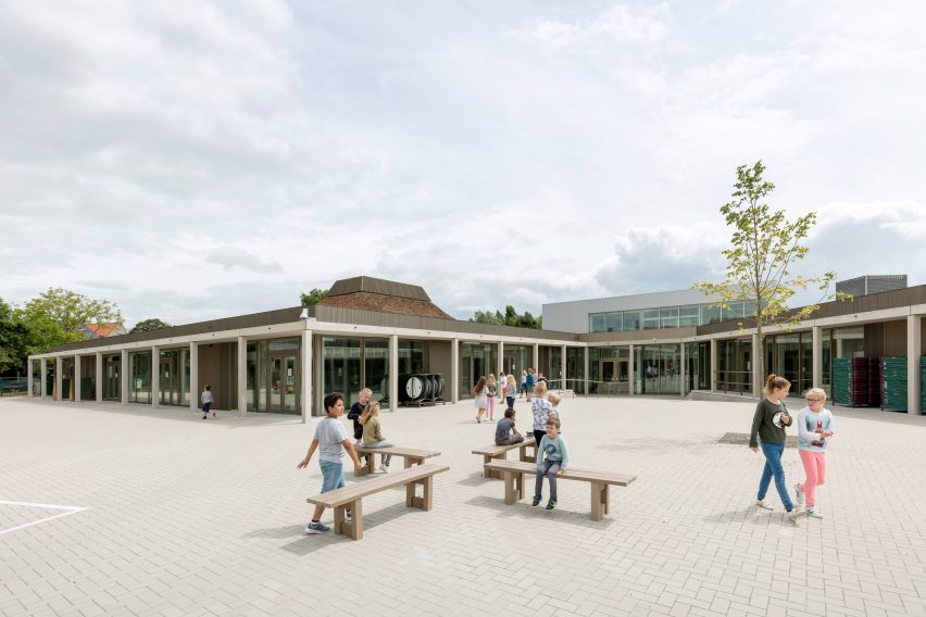 NL Architects completes Belgian school featuring low-lying rooms surrounded by a colonnade