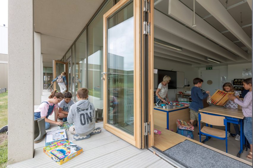 NL Architects completes Belgian school featuring low-lying rooms surrounded by a colonnade