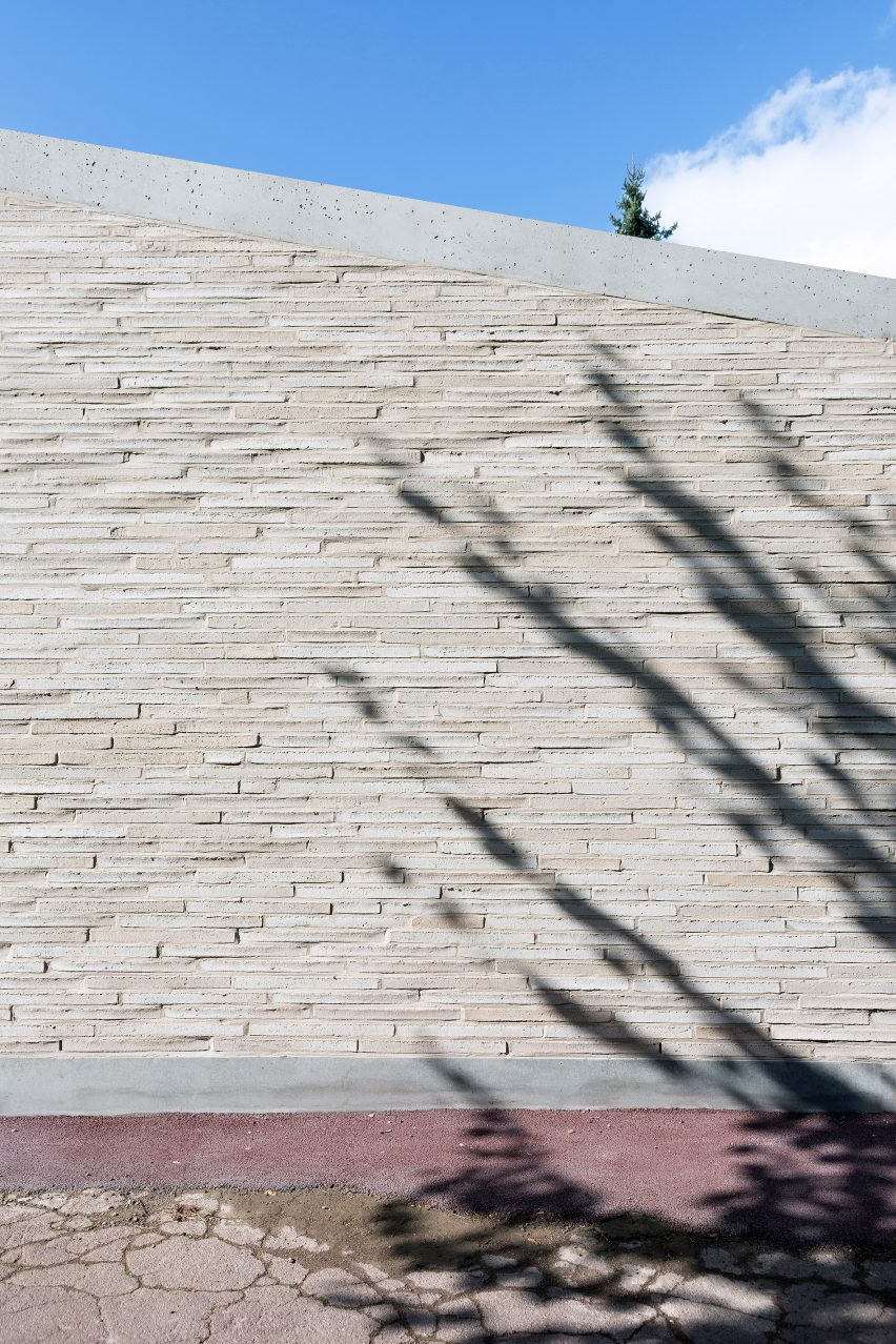 LT2A's brick school extension features porthole-like screens and gold-hued surfaces