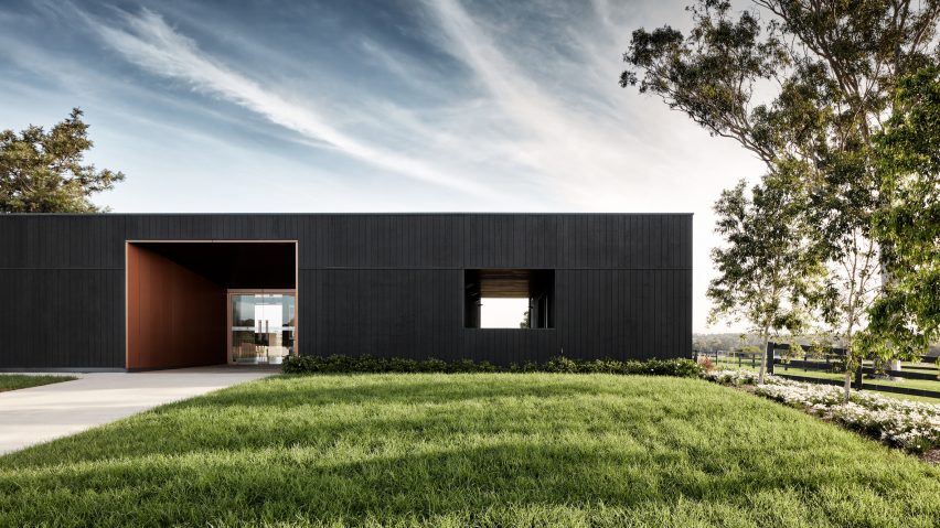 Those Architects extends former dairy farm with black-stained sales office