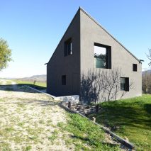 Italian holiday home by 35a Studio features pointed roof and bare concrete interior