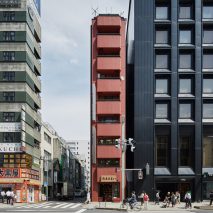 Schemata Architects creates red-toned interior for Tokyo grocery store inside skinny tower