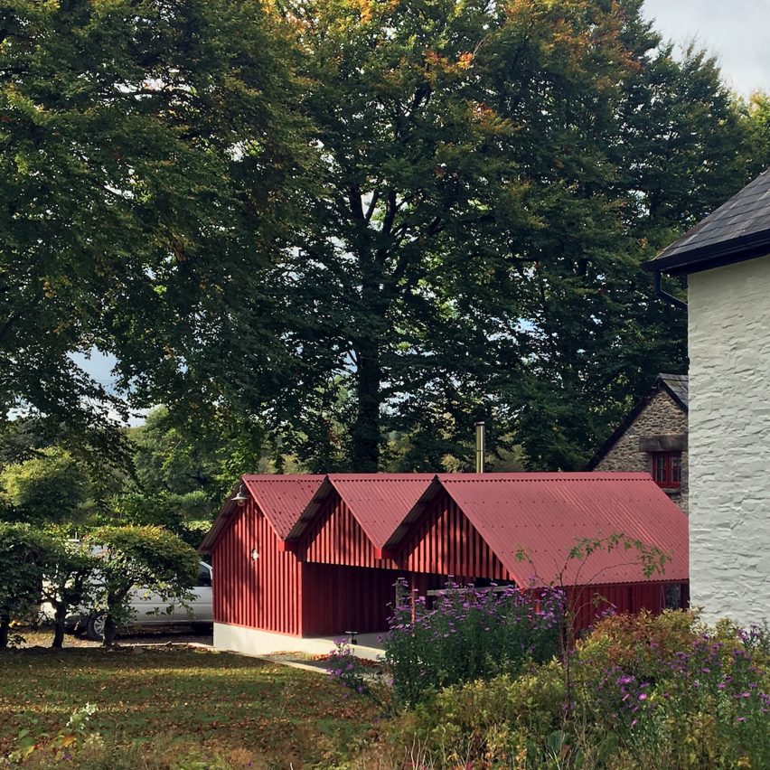 Rural Office for Architecture adds row of red gabled sheds to rural Welsh property