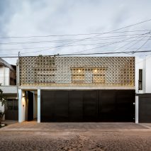 Concrete latticework and two courtyards filter light into Mexican house by Delfino Lozano