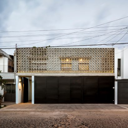 Concrete latticework and two courtyards filter light into Mexican house by Delfino Lozano