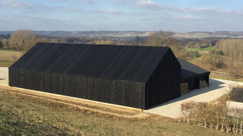 Black-stained barn built by Macdonald Wright Architects at Caring Wood country house
